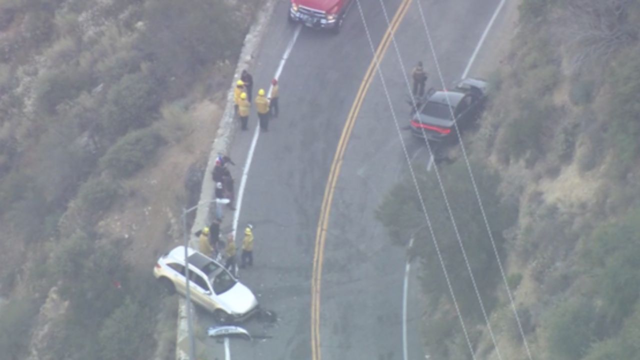 Car dangles off Mt. Baldy cliff after crash — 1 rushed to hospital, investigation underway
